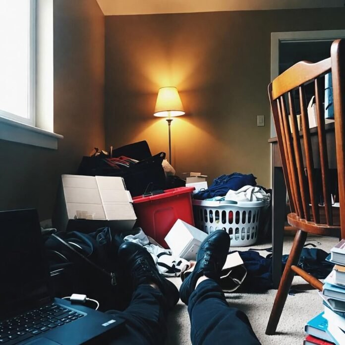 Person collapsed on apartment floor amid packing mess