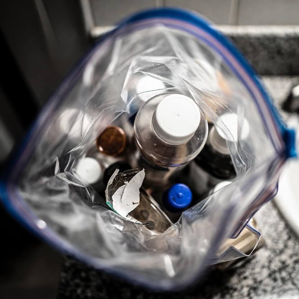Overhead view of chaotic post-flight quart bag on bathroom counter.
